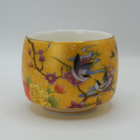 Hand-painted porcelain teacup with floral and bird patterns