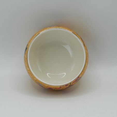Hand-painted porcelain teacup with floral and bird patterns